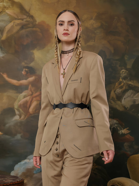 Side view of a beige suit with a black high-waist belt, adding a structured touch.