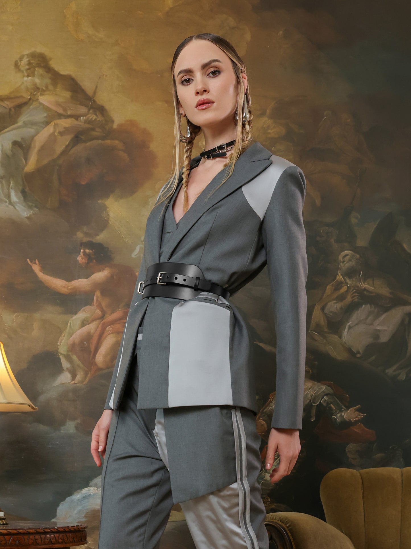 Fashion wide leather waist belt for women on tailored blazer outfit.