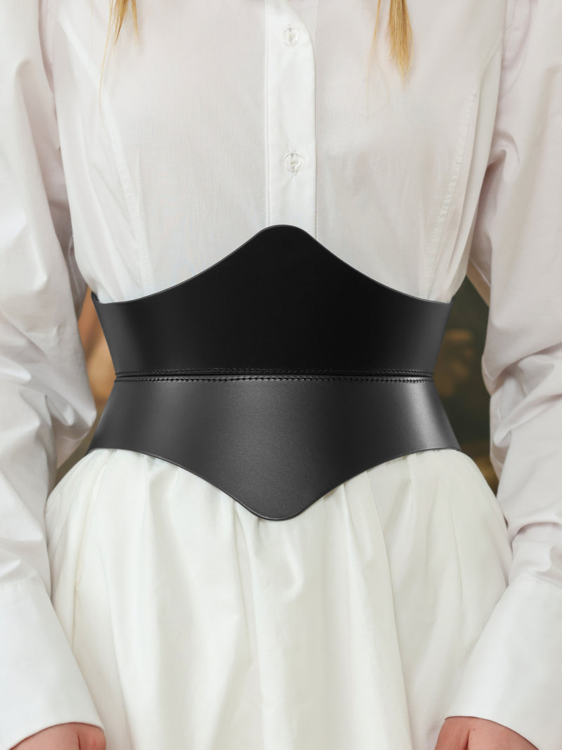 Close-up of a black leather hourglass corset belt over a white shirt dress, showing detailed stitching and sleek curves.