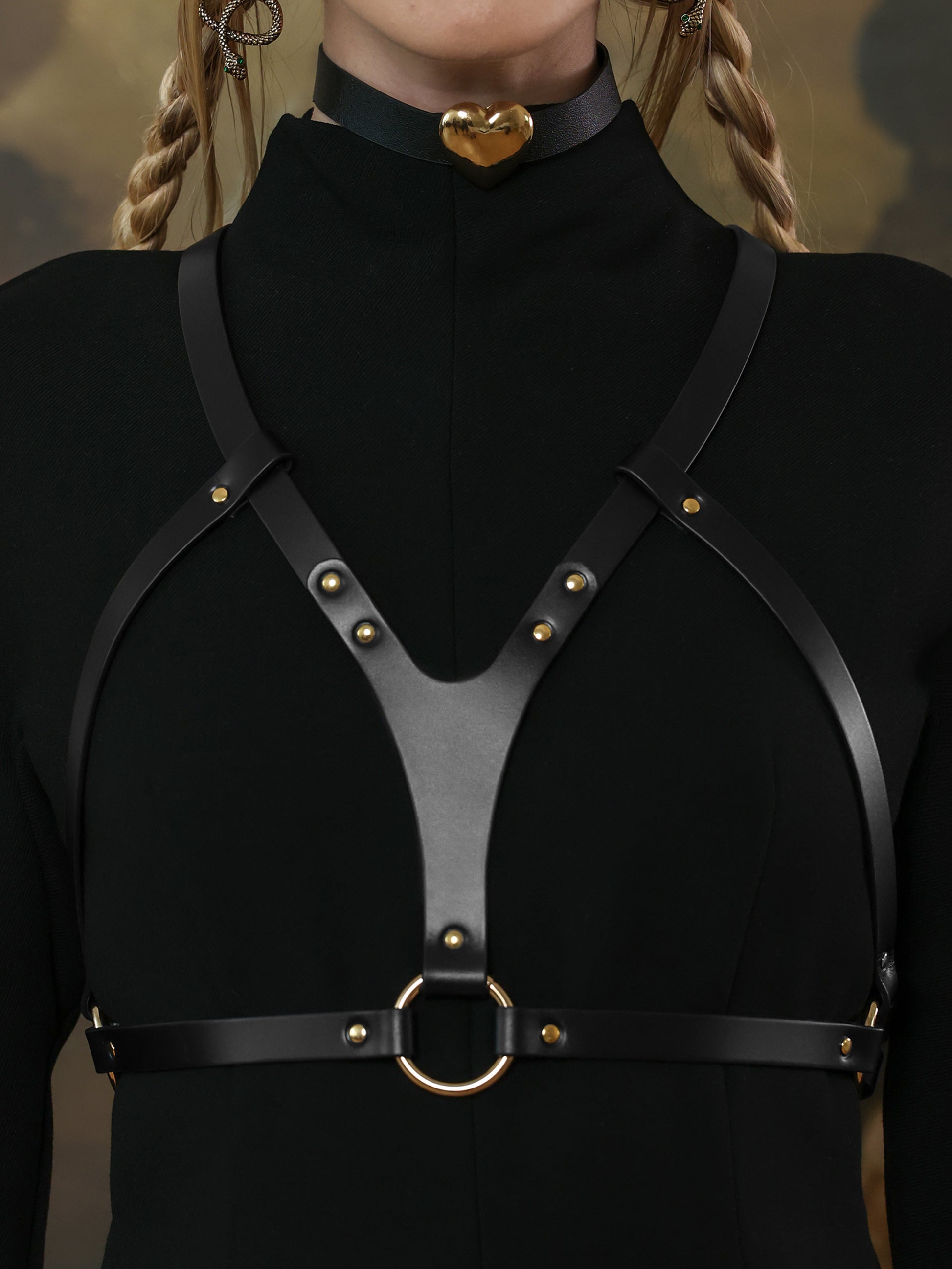 Black chest leather harness with gold hardware – edgy outfit piece.