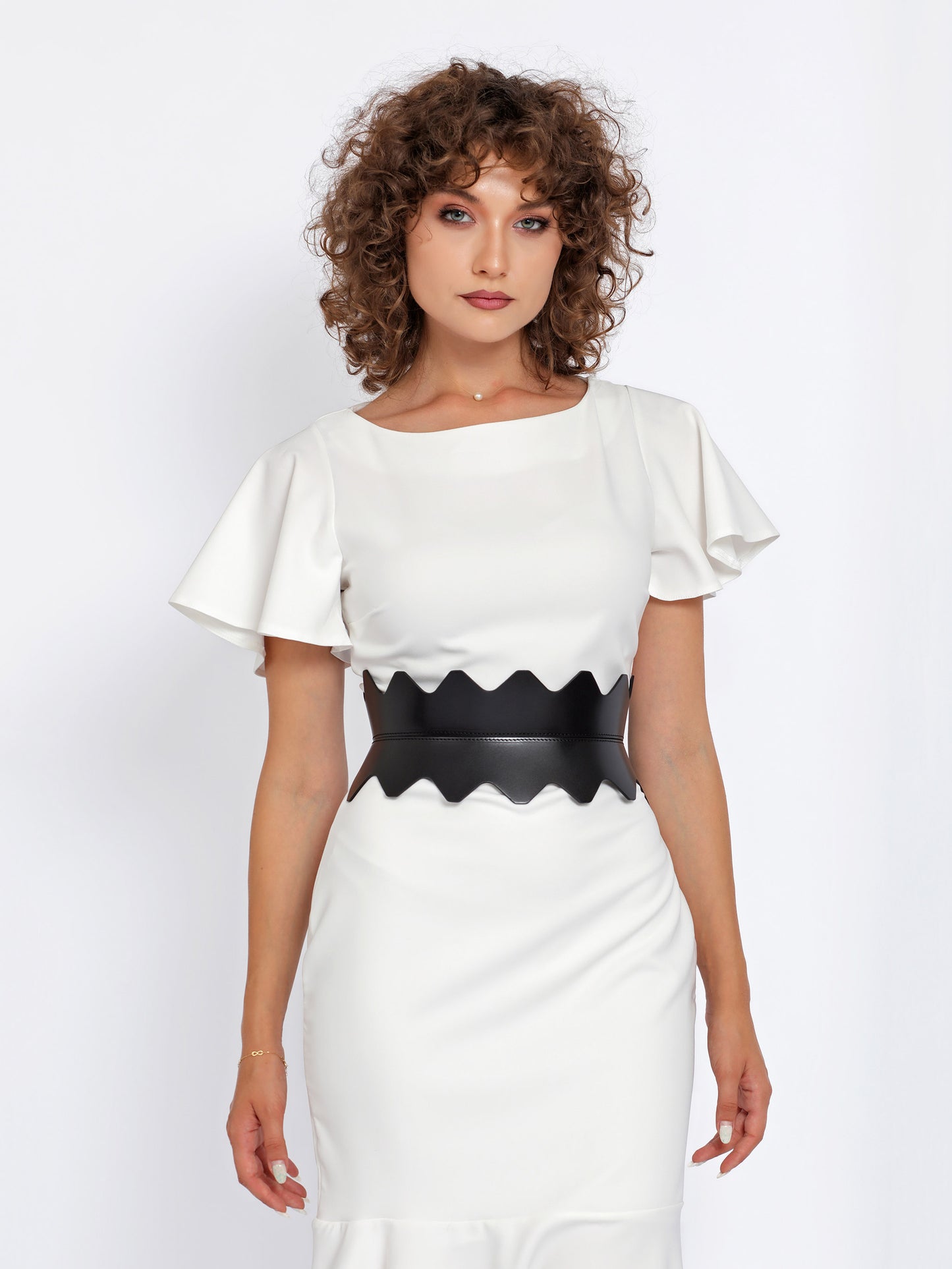 Front view of black hourglass belt being worn over white dress.