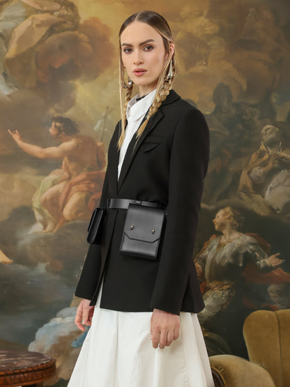 Black leather double pocket belt bag styled with blazer and white skirt.
