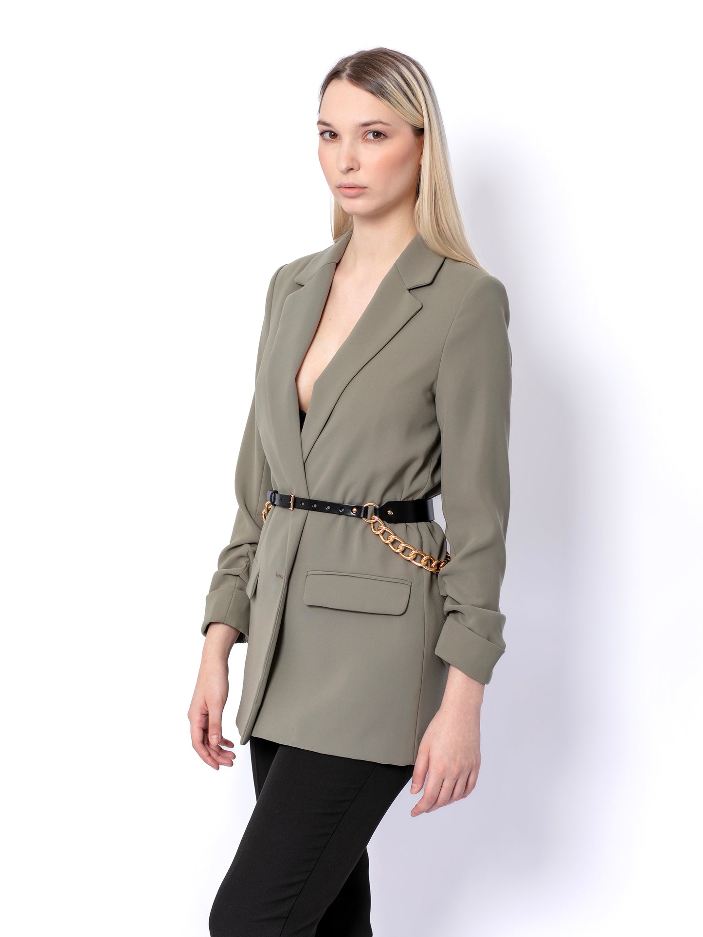 Side view of double chain belt worn by woman oer green blazer.