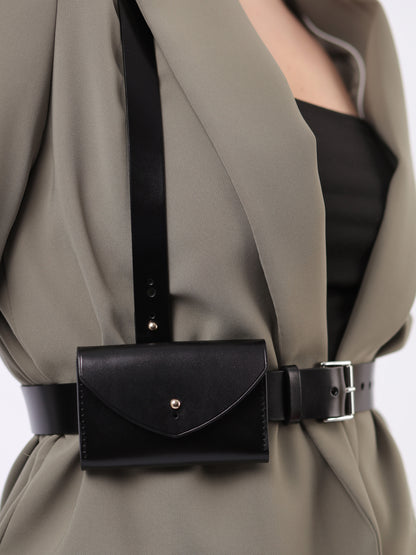 Detailed view of leather slim envelope harness.