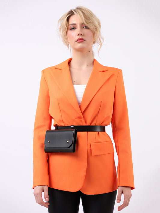 Black envelope belt bag fitted on woman wearing orange blazer.