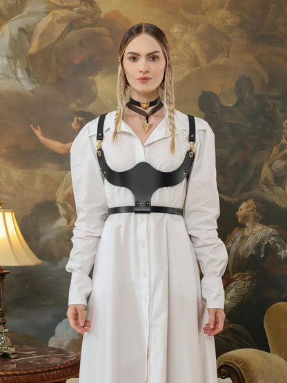 Fashion look featuring a black leather underbust harness worn over a white shirt dress, front view.