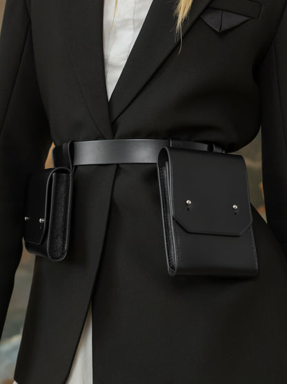 Close-up of black leather double pocket waist belt bag for women.