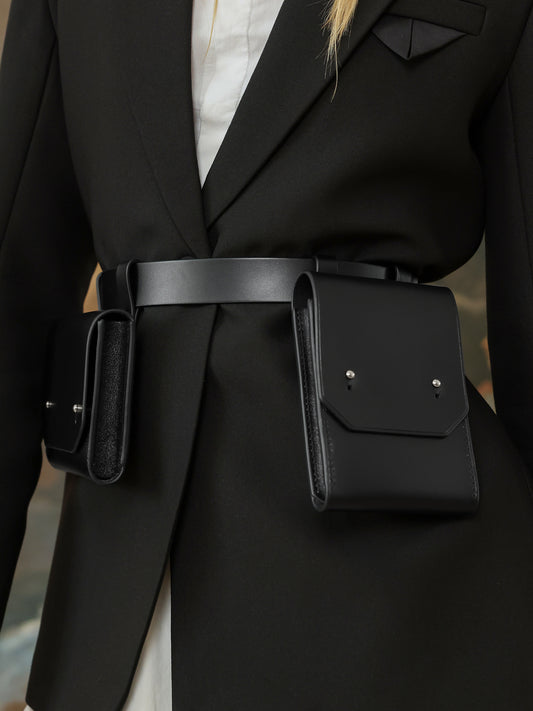 Close-up of black leather double pocket waist belt bag for women.