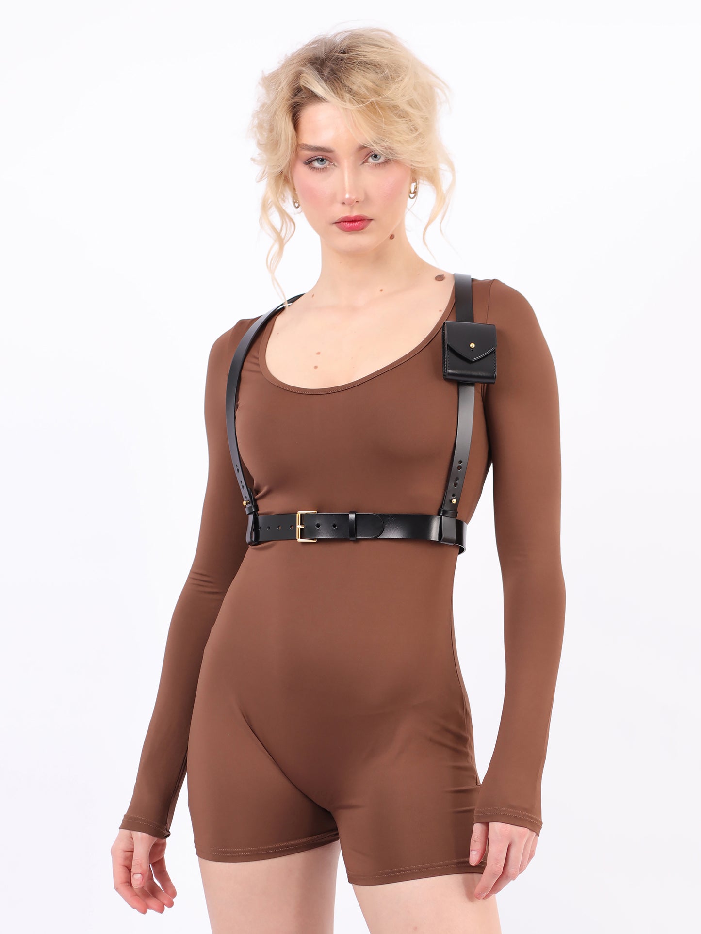 Black micro bag harness fited on model wearing brown jumpsuit.