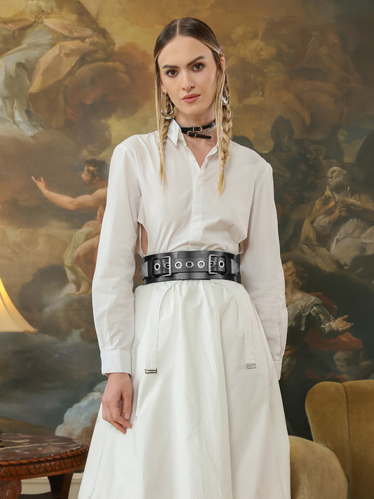 High waist black leather grommet belt paired with a white button-down dress.