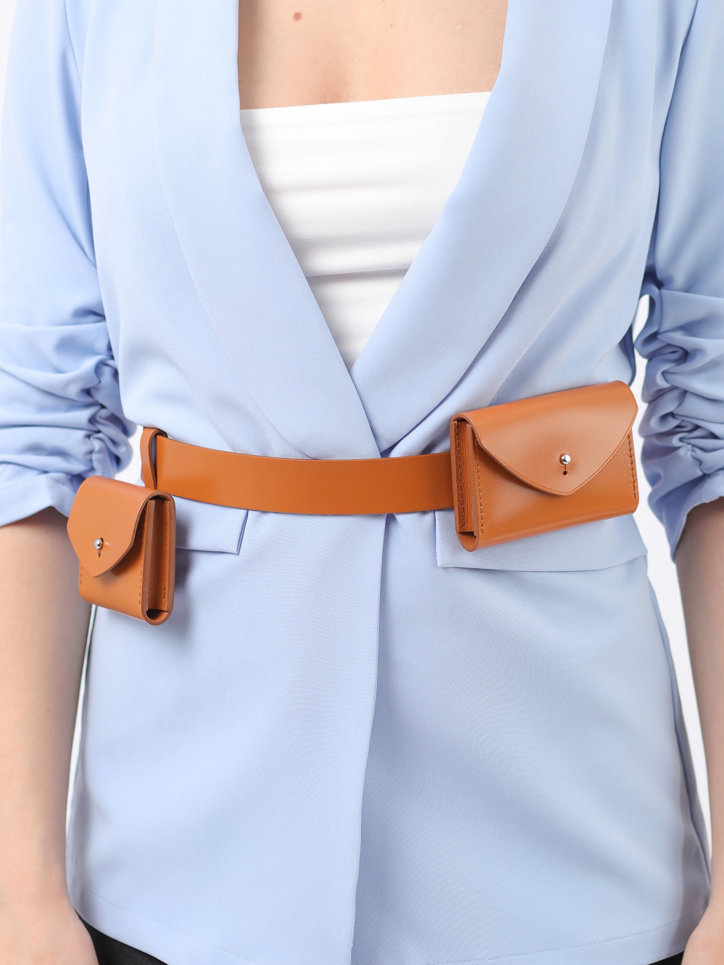Detailed view of brown double micro belt bag.