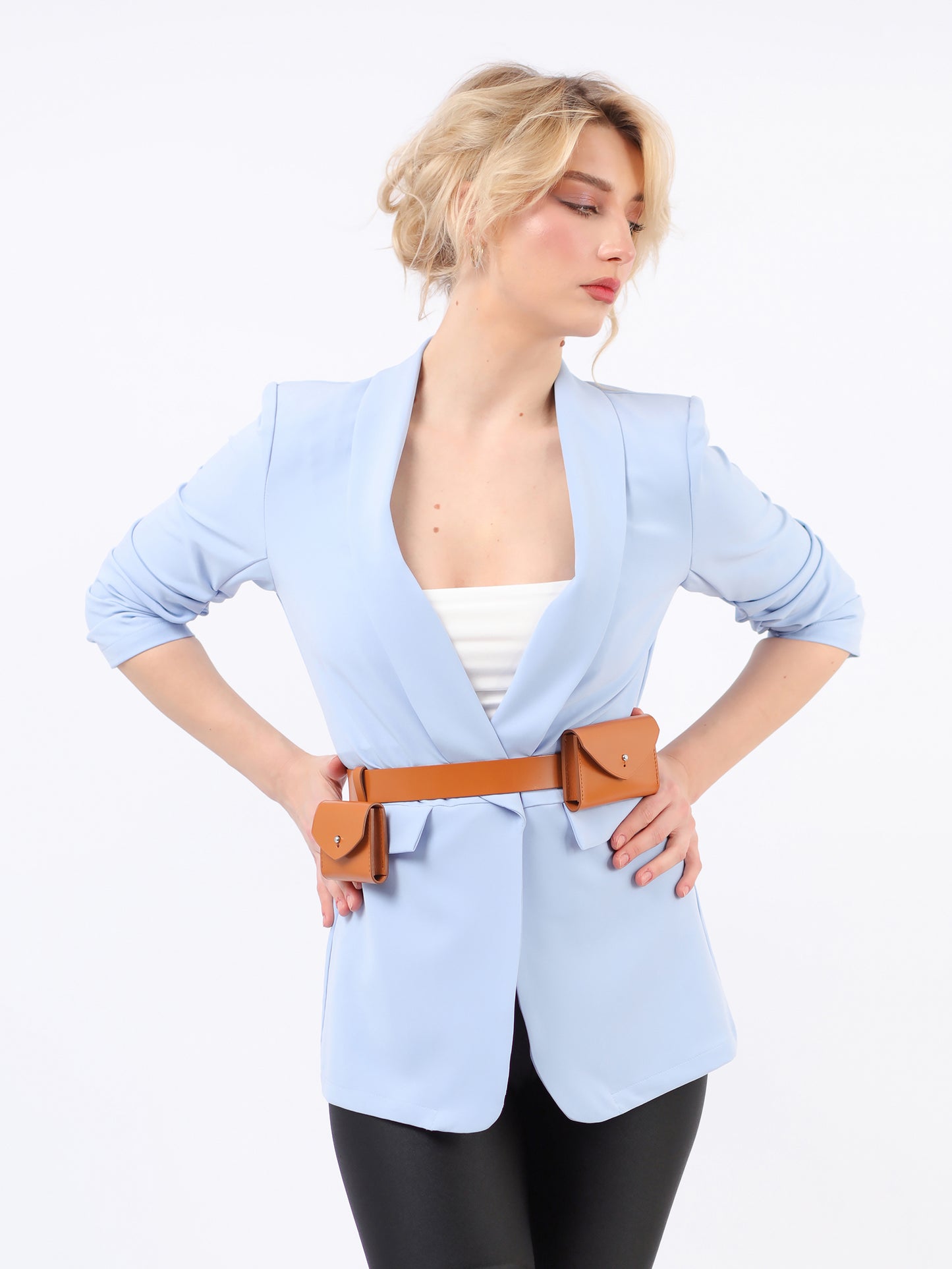 Brown double micro belt bag fitted on woman wearing blue blazer.