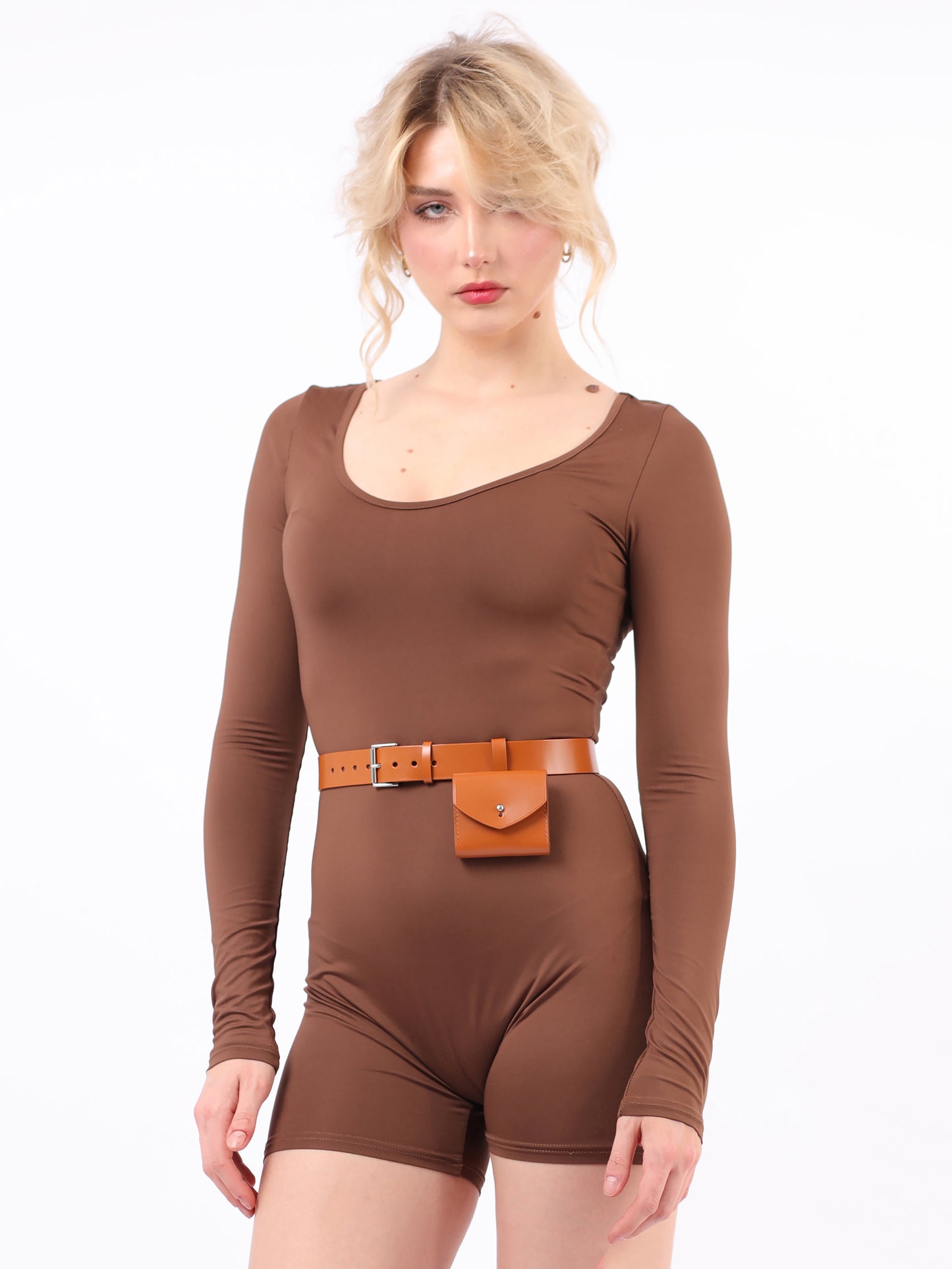 Light brown micro belt bag fitted on woman wearing brown jumpsuit.