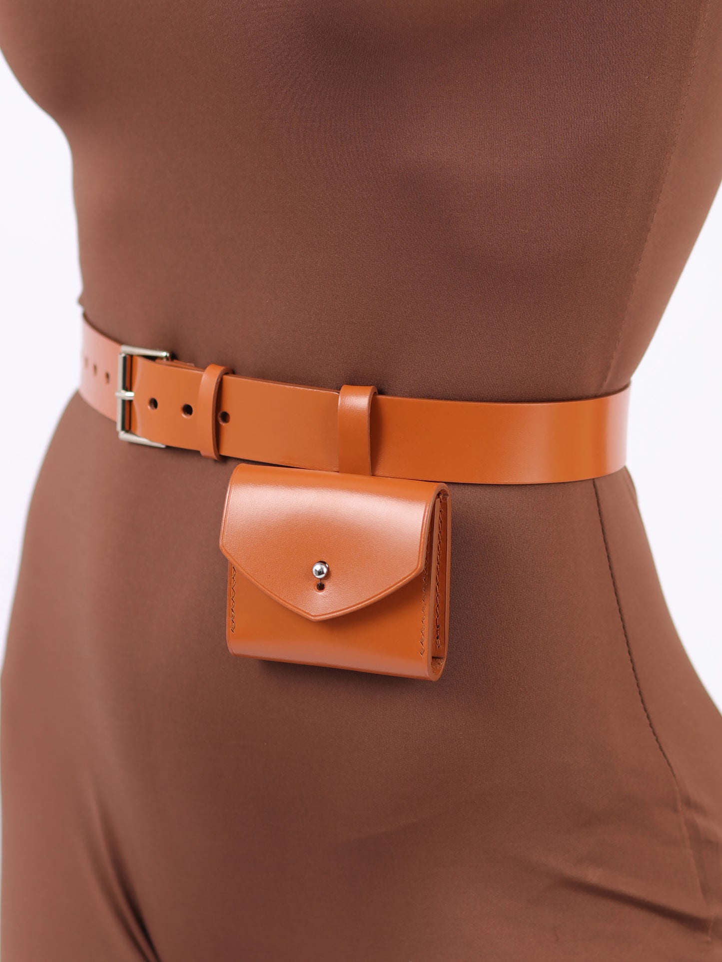 Detailed view of light brown micro belt bag.