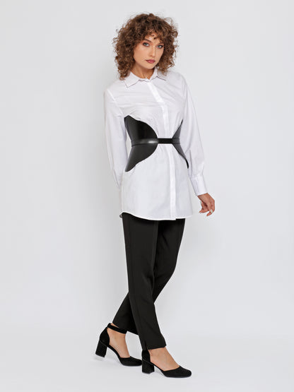 Full outfit view of black wide leather belt worn over white shirt.