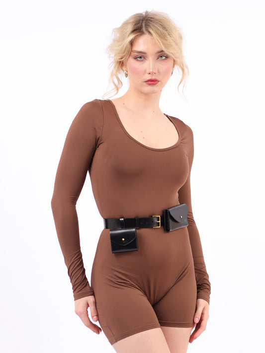 Double micro belt bag fitted on woman wearing brown jumpsuit.