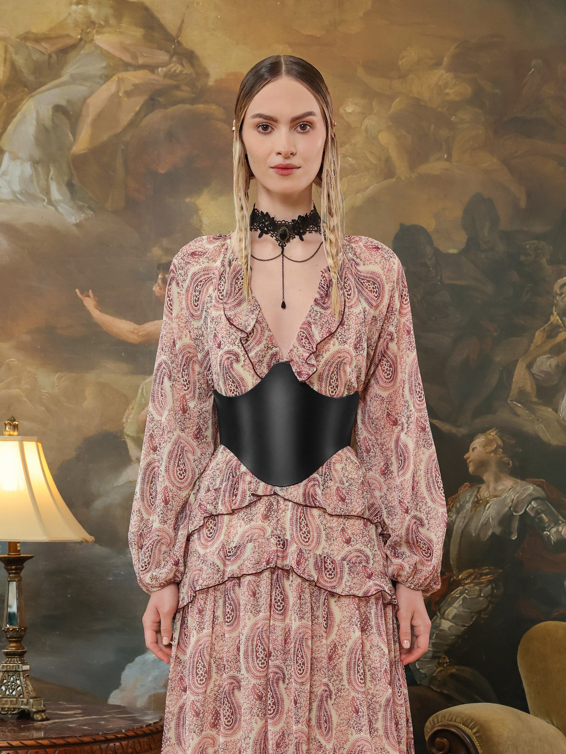 Back view of a paisley dress paired with a structured black leather underbust belt featuring double buckle details.