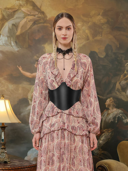 Back view of a paisley dress paired with a structured black leather underbust belt featuring double buckle details.