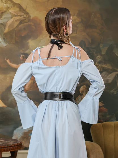 Back view of a black leather wide waist belt styled with a light blue off-shoulder gown.