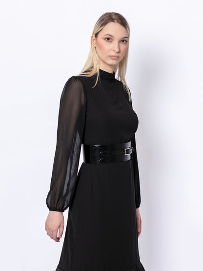 Side view of wide corset belt worn by model over black dress.