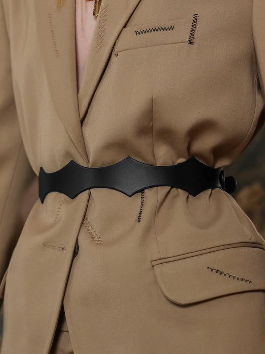 Back view of a beige suit styled with a black leather waist belt.