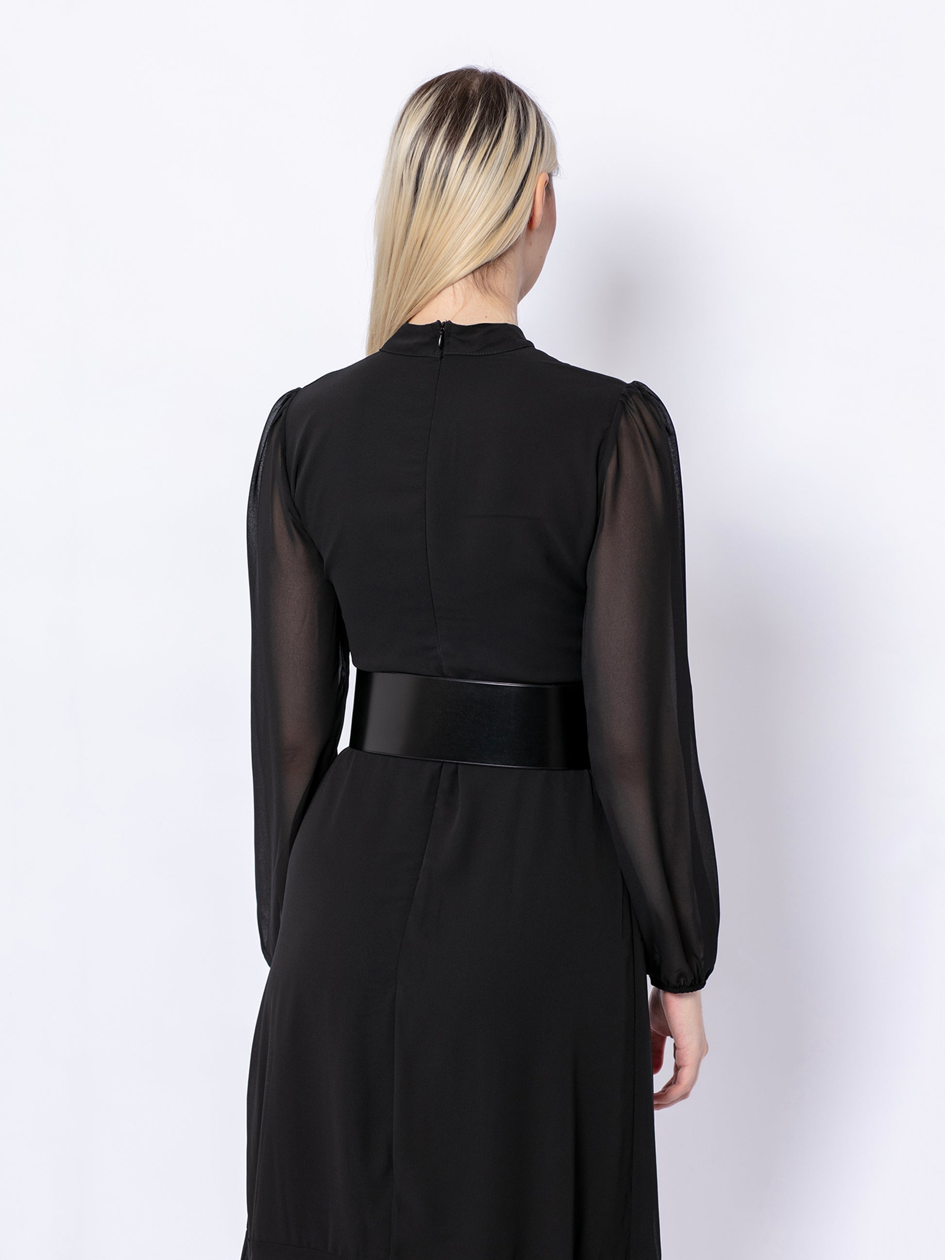 Back view of wide corset belt worn by model over black dress.