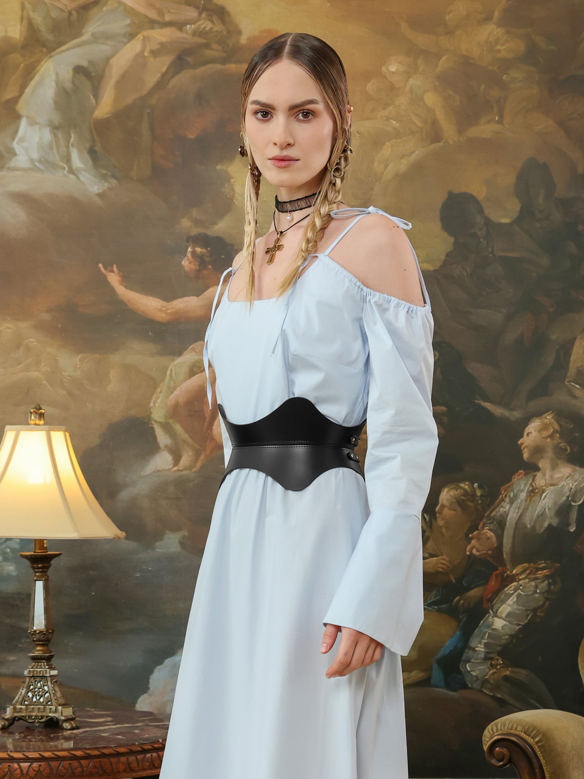 Hourglass fashion leather belt in black with sculpted curves for waist shaping and style.