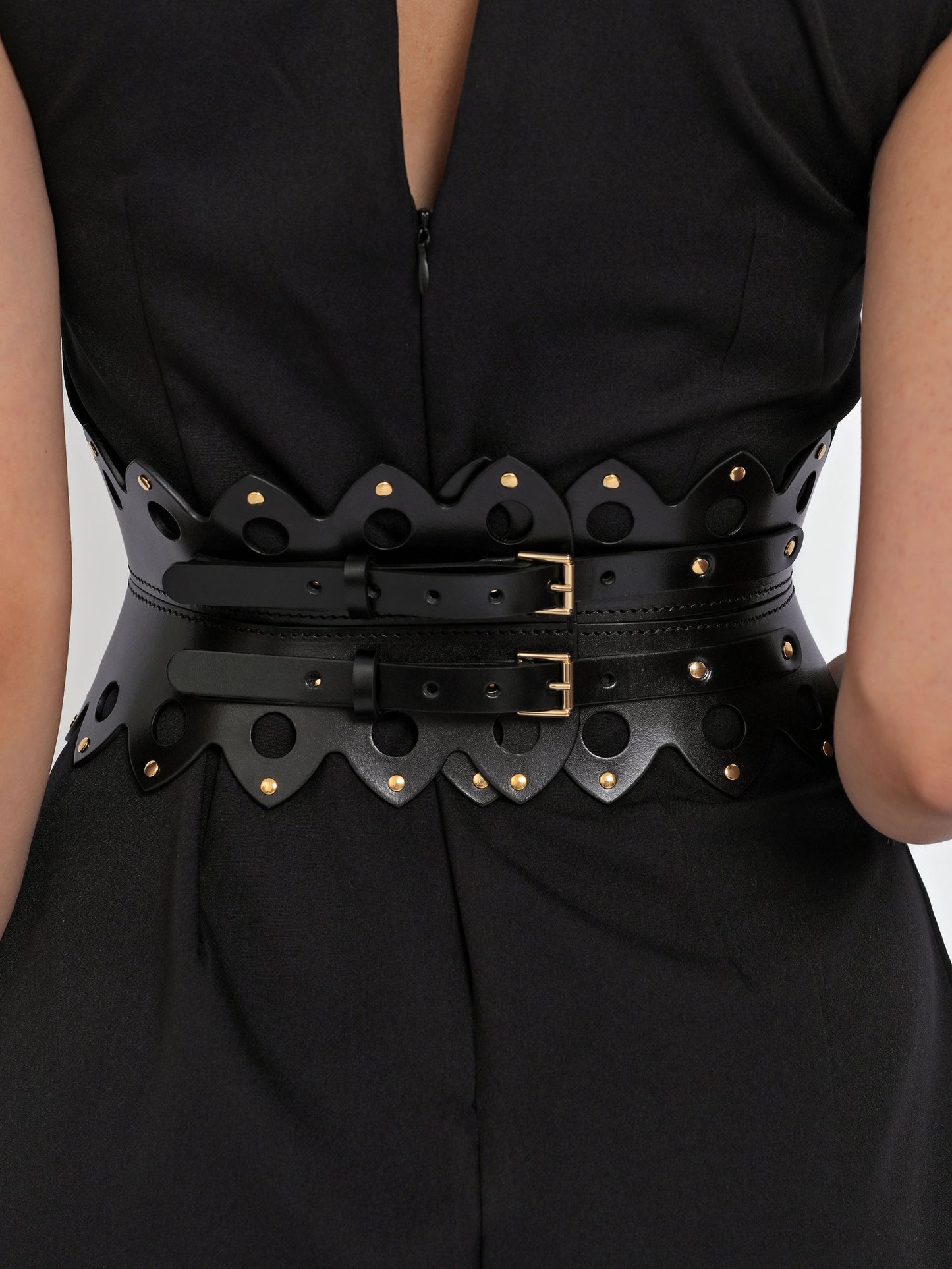 Back view of hourglass corset belt being worn over black dress.