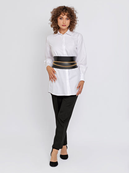 Full outfit view of black leather corset belt being worn over white shirt and black trousers.