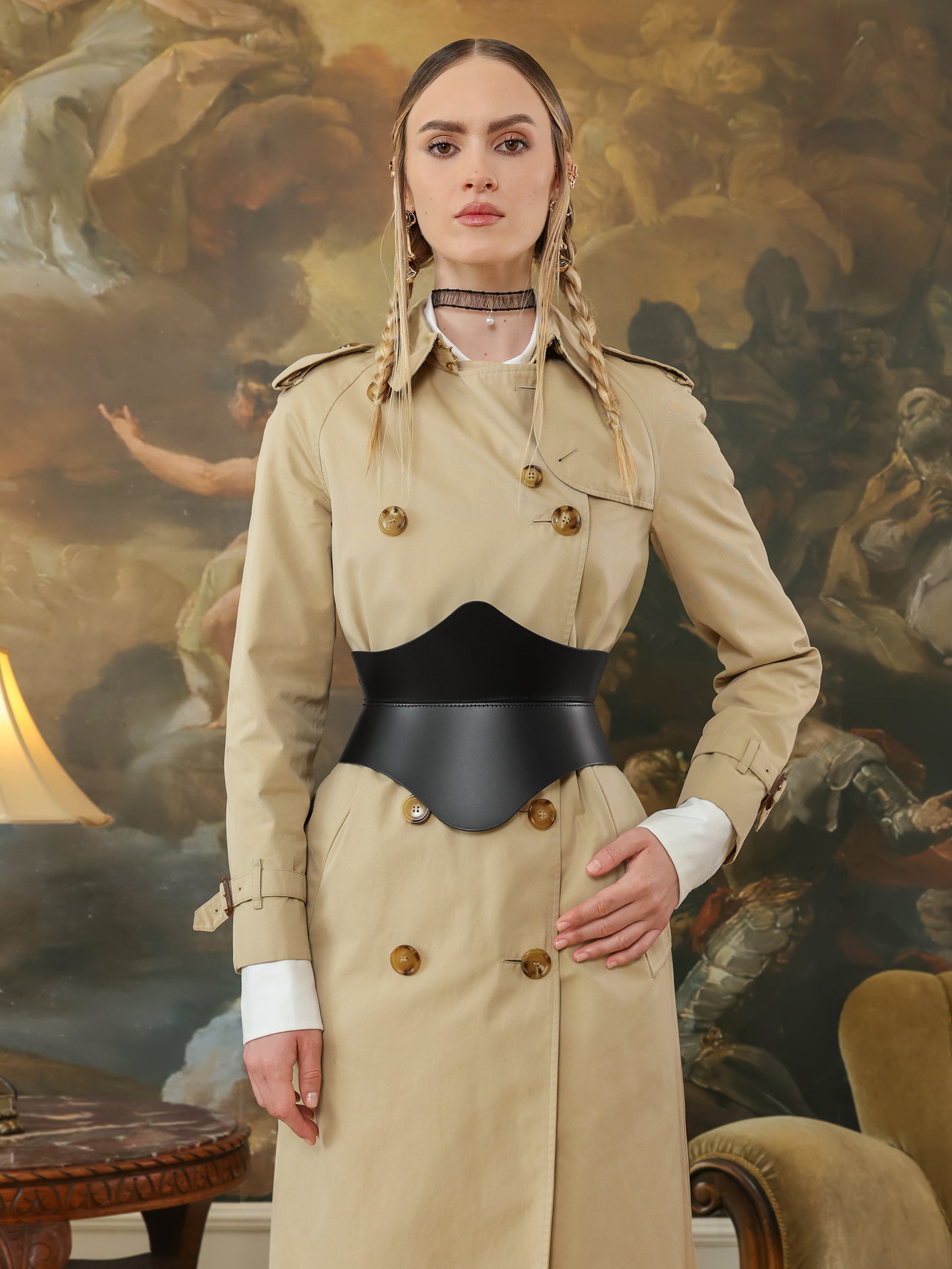 Front view of high waist black hourglass corset belt on beige trench coat.
