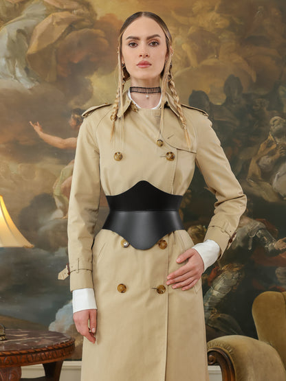 Front view of high waist black hourglass corset belt on beige trench coat.