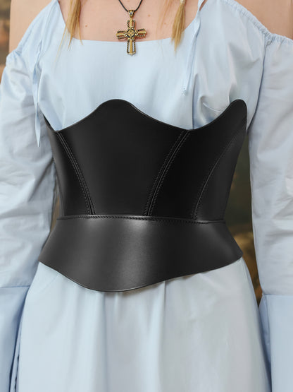 Close up of black leather underbust corset belt styled over a light blue off-shoulder dress.