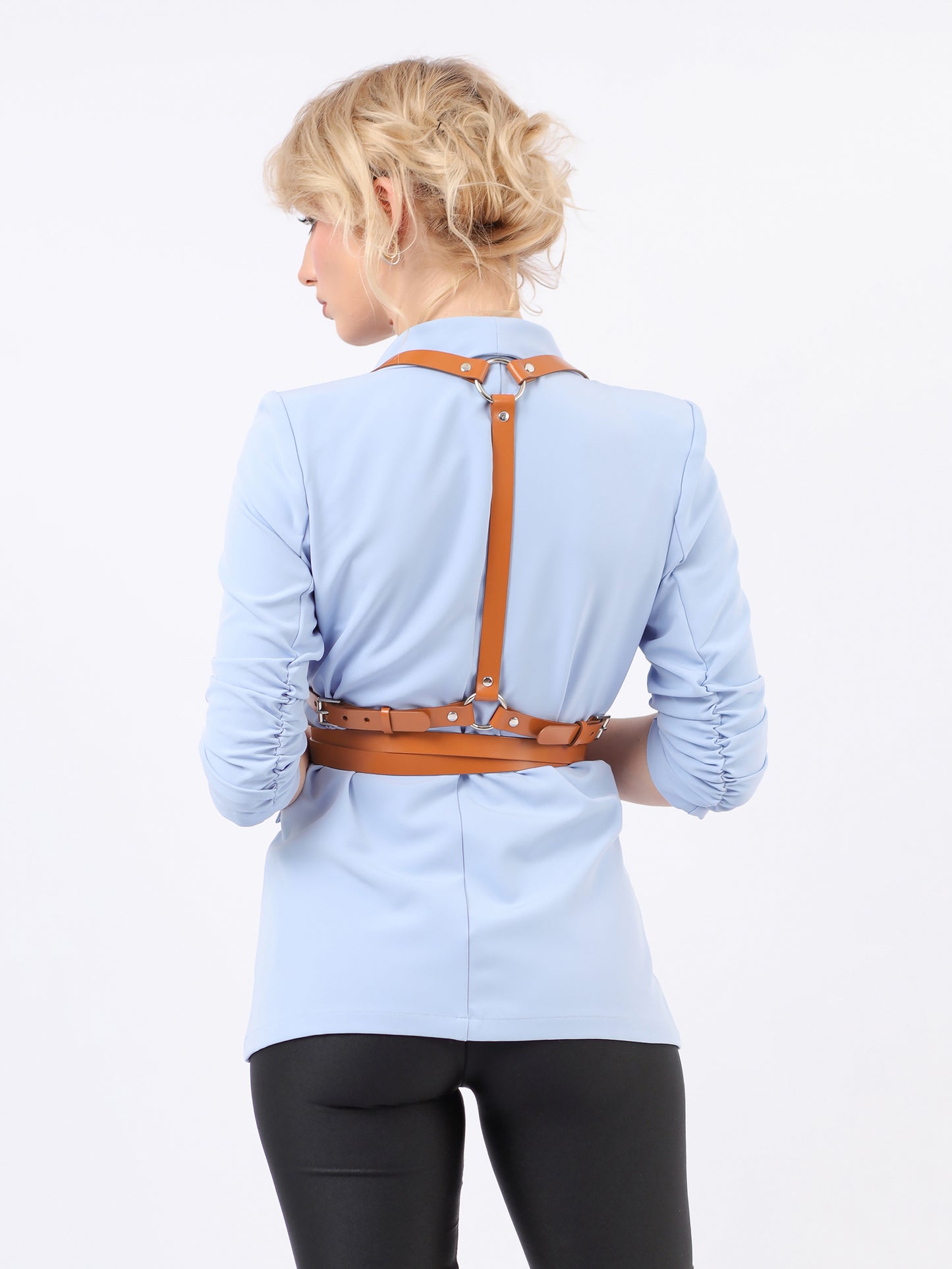 Back view of double belt harness fitted on woman wearing blue blazer.
