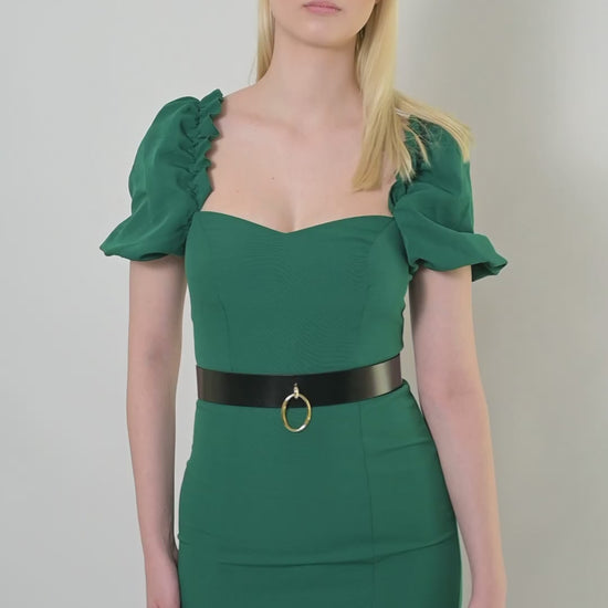 Video of high waist leather belt worn over green dress.