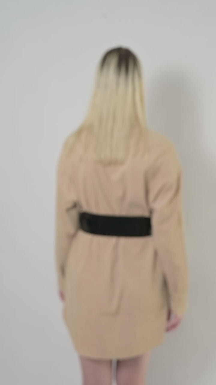 Video of black leather corset belt worn by model over beige shirt.