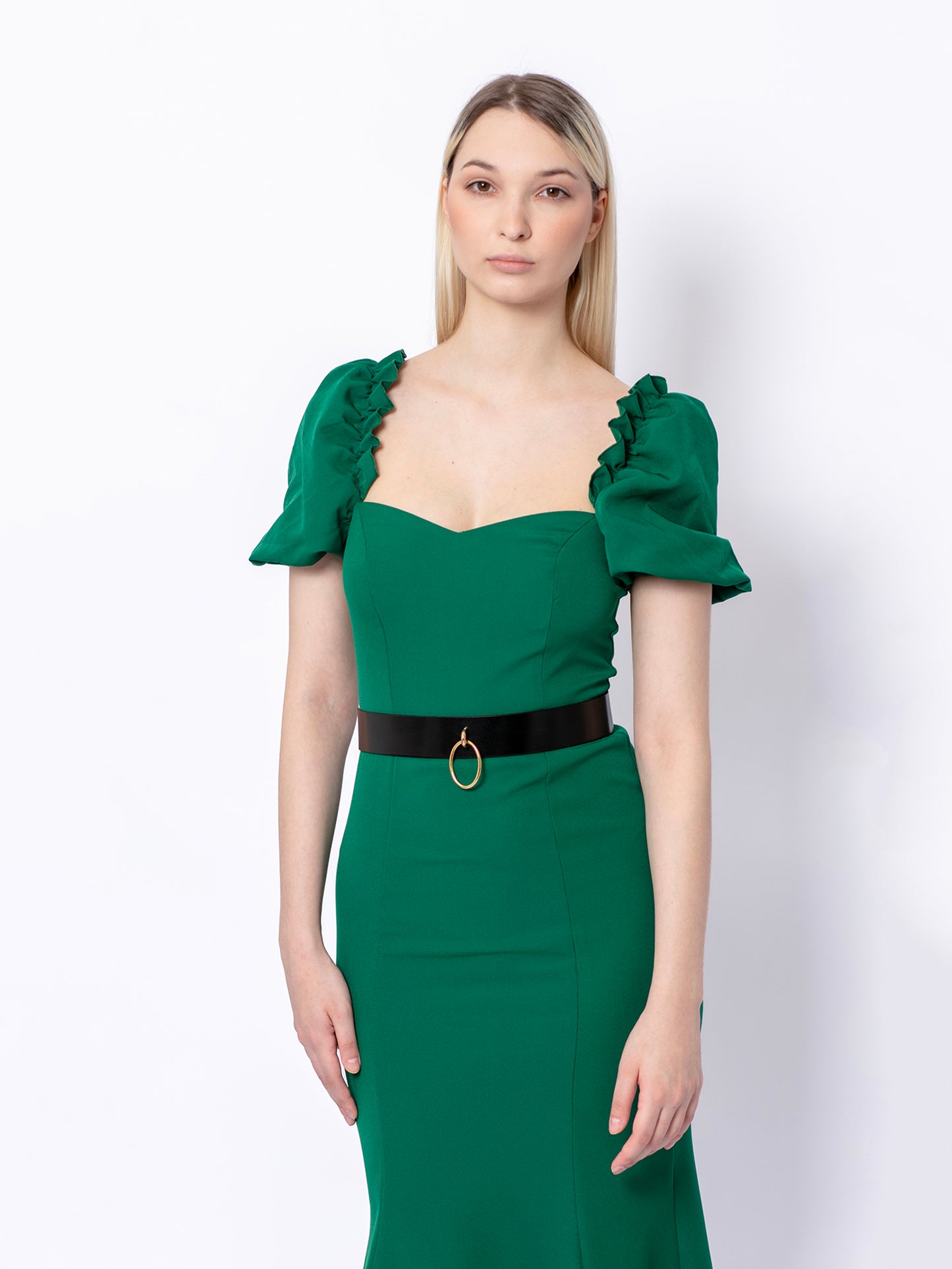 Front view of high waist leather belt worn over green dress.