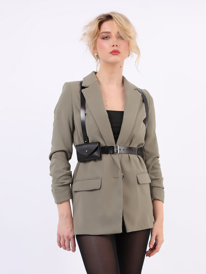 Slim envelope harness fitted on woman wearing green blazer.