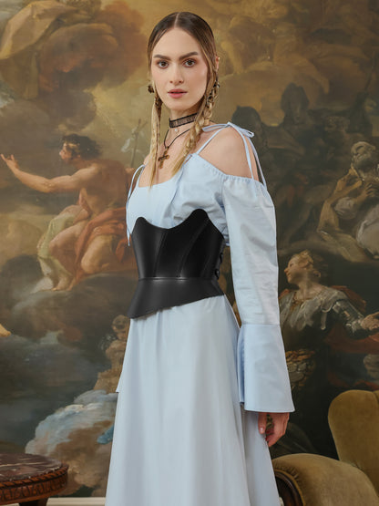 Side angle of a black leather underbust corset styled with a blue off-shoulder dress.