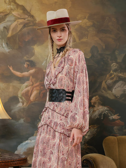 Wide black leather waist belt with bold cutout details, paired with a flowing bohemian dress.