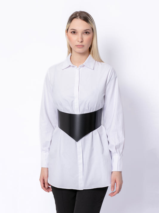 Woman wearing black corset belt over white shirt
