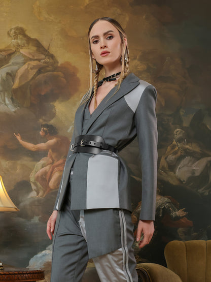 Fashion wide leather waist belt for women on tailored blazer outfit.
