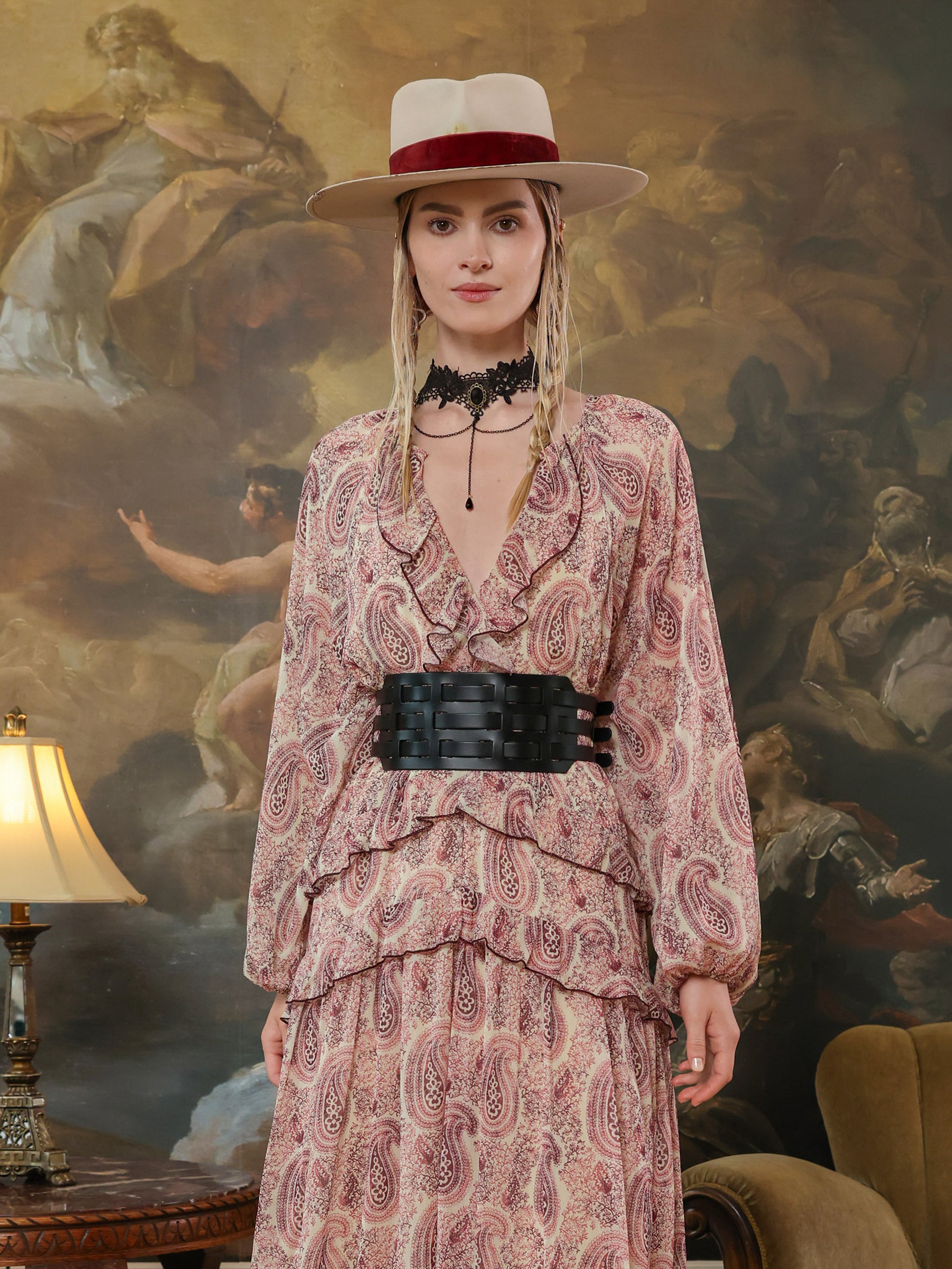 Corset-inspired black waist belt with modern cutout pattern, styled for a high-fashion look.