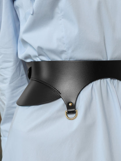 Close-up of black leather waist belt with gold D-ring detail on blue gown.