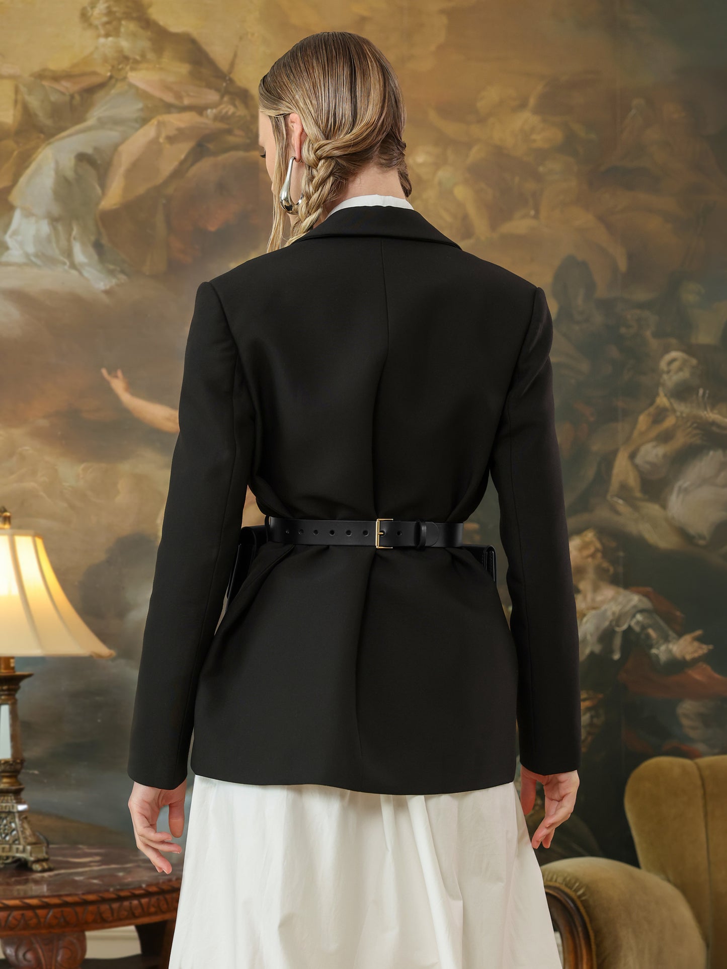 Back view of black leather waist belt bag with adjustable buckle.