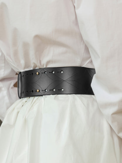 Back view of a wide black leather waist belt with gold buckle details.
