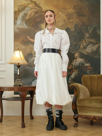Full outfit view of a wide leather waist belt styled with a white dress and black combat boots.