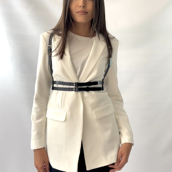 Double belt fashion harness fited on white blazer.