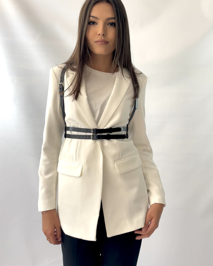 Double belt fashion harness fited on white blazer.