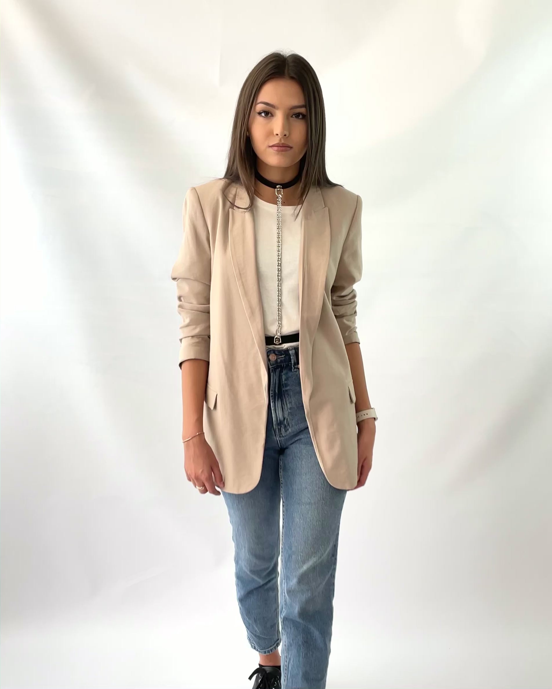 Leather women chain harness worn with blazer.
