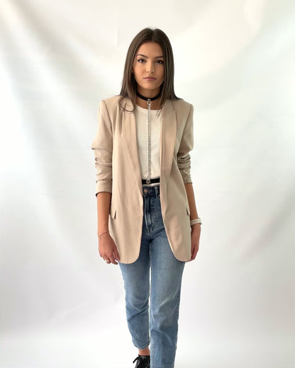 Leather women chain harness worn with blazer.